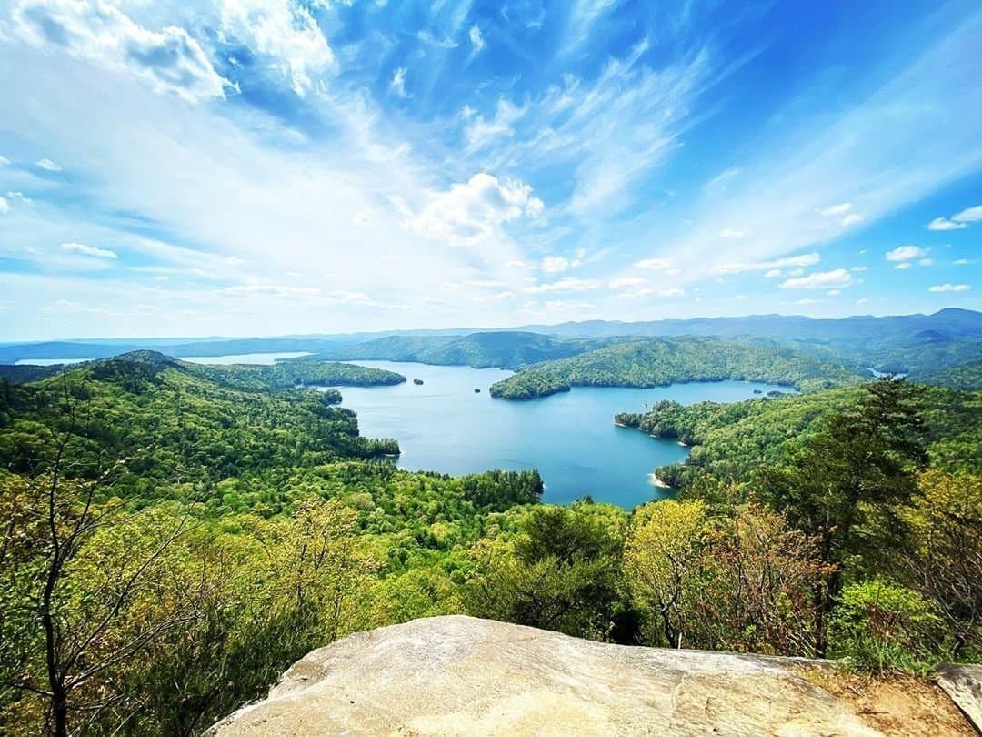 Lake Jocassee winding between forested ridges, viewed from a rock overlook.